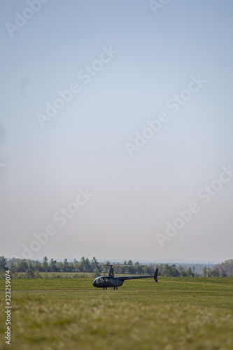 Helicopter taking off from a field