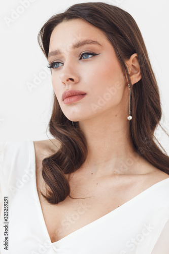 Portrait of elegant beautiful bride wearing fashion wedding dress. Perfect makeup and hairstyle
