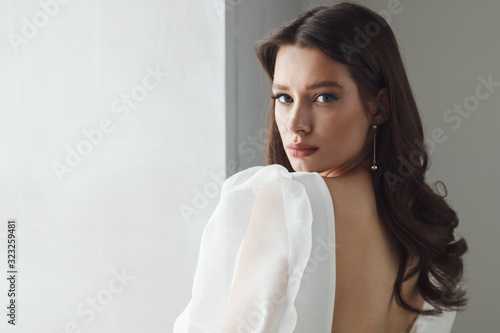 Portrait of elegant beautiful bride wearing fashion wedding dress. Perfect makeup and hairstyle