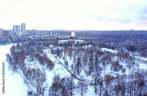 park landscape with manor and temple shot from a quadrocopter in winter