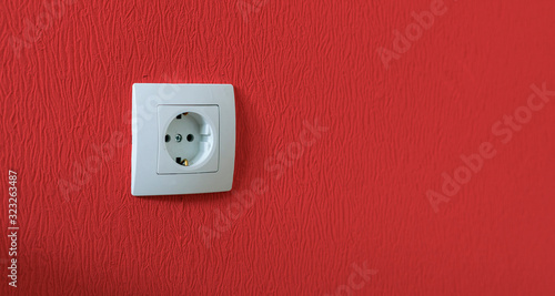 simple single white electricity socket in the wall at home apartment