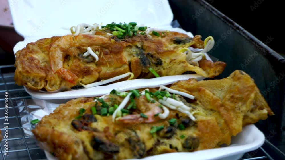 Oyster omelette with shrimp or Thai-style fried mussels, popular Thai street food Oyster omelette with shrimp or Thai-style fried mussels, popular Thai street food