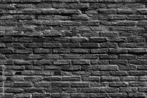 The background of the black and white grunge old brick wall in the house or any building. 