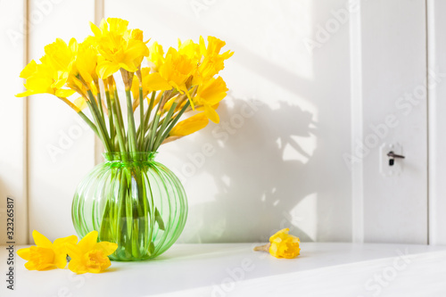 Wallpaper Mural bright sunlight shines on Easter bells, daffodils flowers in vase on the windowsill. country style bouquet for spring decoration or Easter decoration against open background with copy space Torontodigital.ca