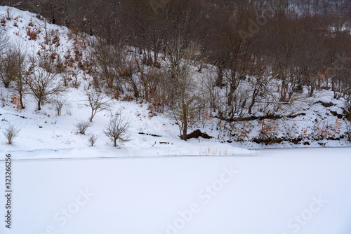 Frozen mountain lake, winter landscape