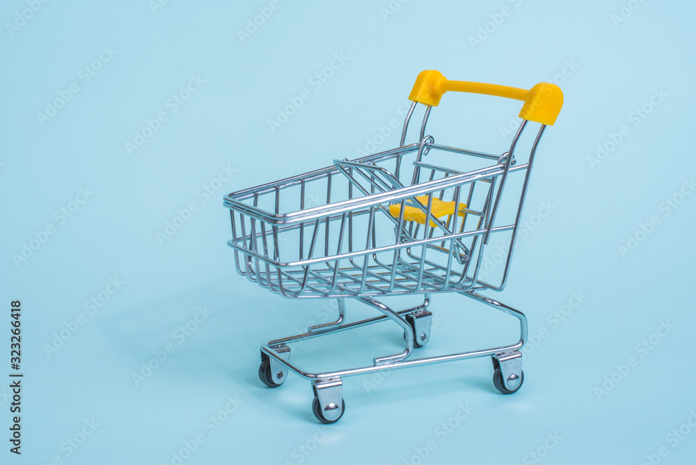 Cart from the supermarket on a blue background. Sell-out. Going to the grocery store. Cart from the supermarket on a blue background. Sell-out. Going to the grocery store.