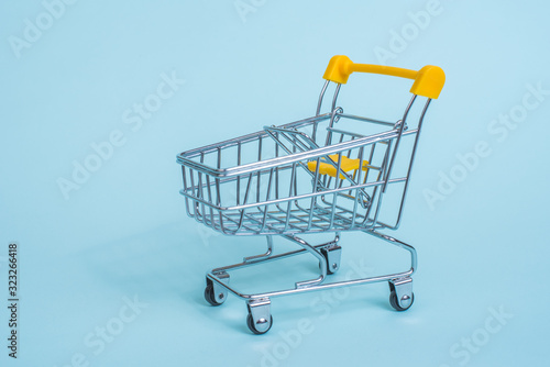 Cart from the supermarket on a blue background. Sell-out. Going to the grocery store.