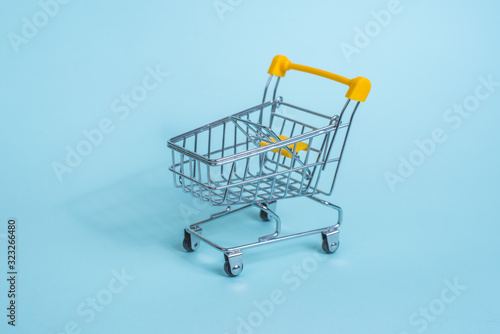 Cart from the supermarket on a blue background. Sell-out. Going to the grocery store.
