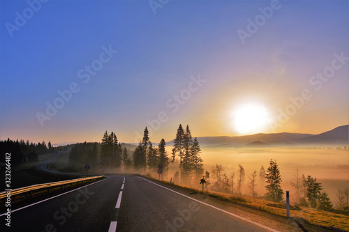 sunrise with fog at the roadside