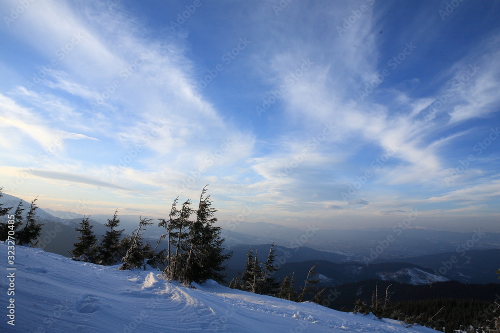 Fototapeta premium Evening light on clouds in mountains
