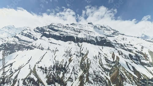 Stunning bottom view on snowy towering Mount Gangapurna, terrific peak, Nepal photo