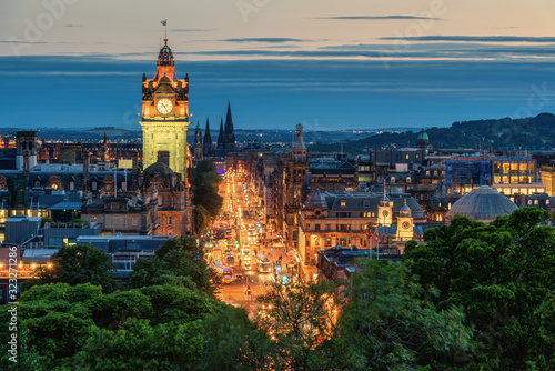 Balmoral's clock tower with Edinburgh cityscape skyline and Scott Monument background during sunset