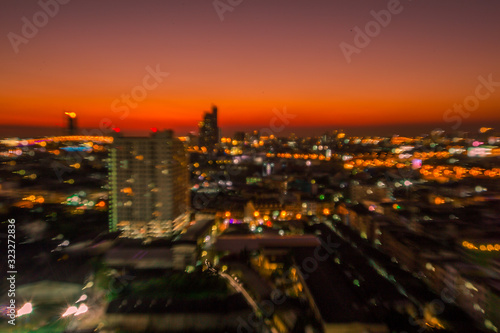 The blurry background of the bokeh, the colorful lights of the capital's residences, the beauty of the night shows the distribution of various types of residences (condominiums, offices, houses). © bangprik