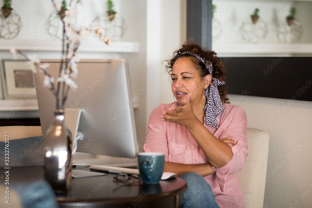 Mixed race woman working from her home office.