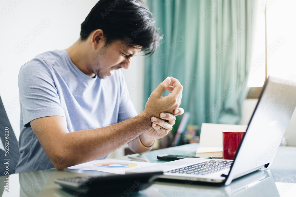 Office syndrome, Young Asian office worker suffering from wrist joint pain Office syndrome, Young Asian office worker suffering from wrist joint pain