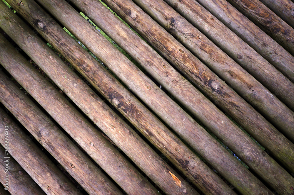Logs of foot bridge. Brown timber texture. 