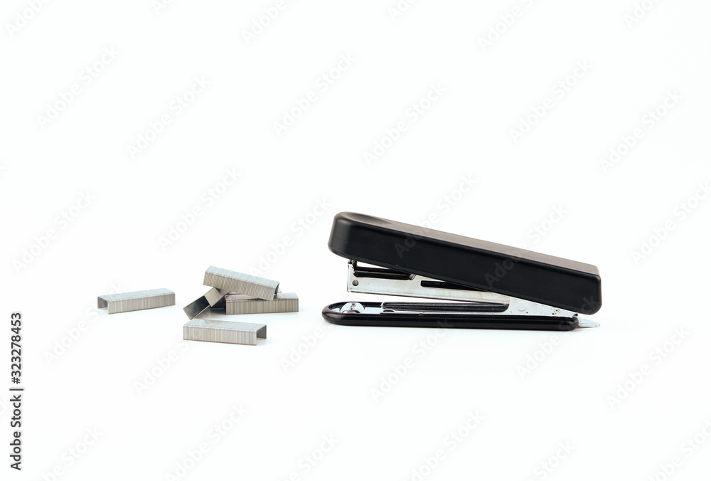 Black stapler and metal staple isolated on a white background. Office Equipment and Work Tool concept Design. Black stapler and metal staple isolated on a white background. Office Equipment and Work Tool concept Design.