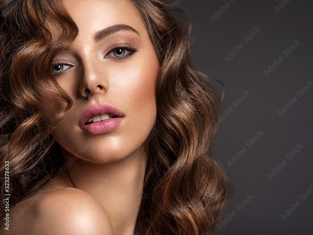 Beautiful woman with brown hair. Beautiful face of an attractive model with fashion makeup. Beautiful woman with brown hair. Beautiful face of an attractive model with fashion makeup.