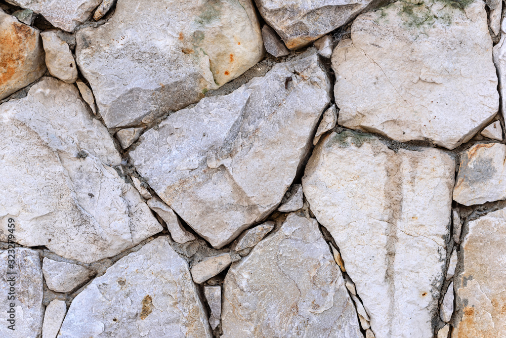 Fototapeta premium Close-up wall of wild rough stone