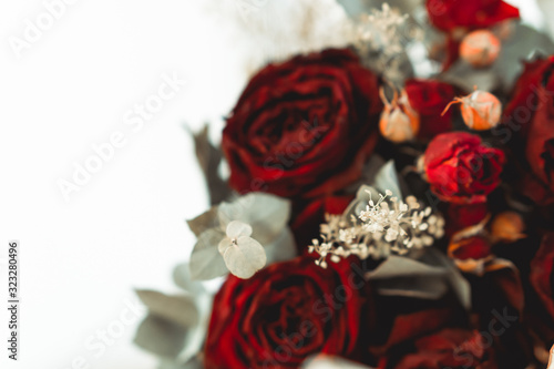 A bouquet of roses in front of a out of focus white background
