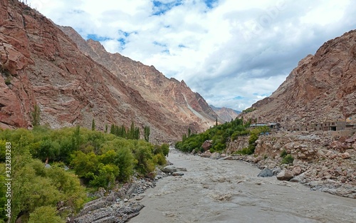 Indus river with bare mountains behind next to Leh, Ladakh