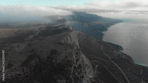 Flying over rocks overlooking the sea and the city in Crimea