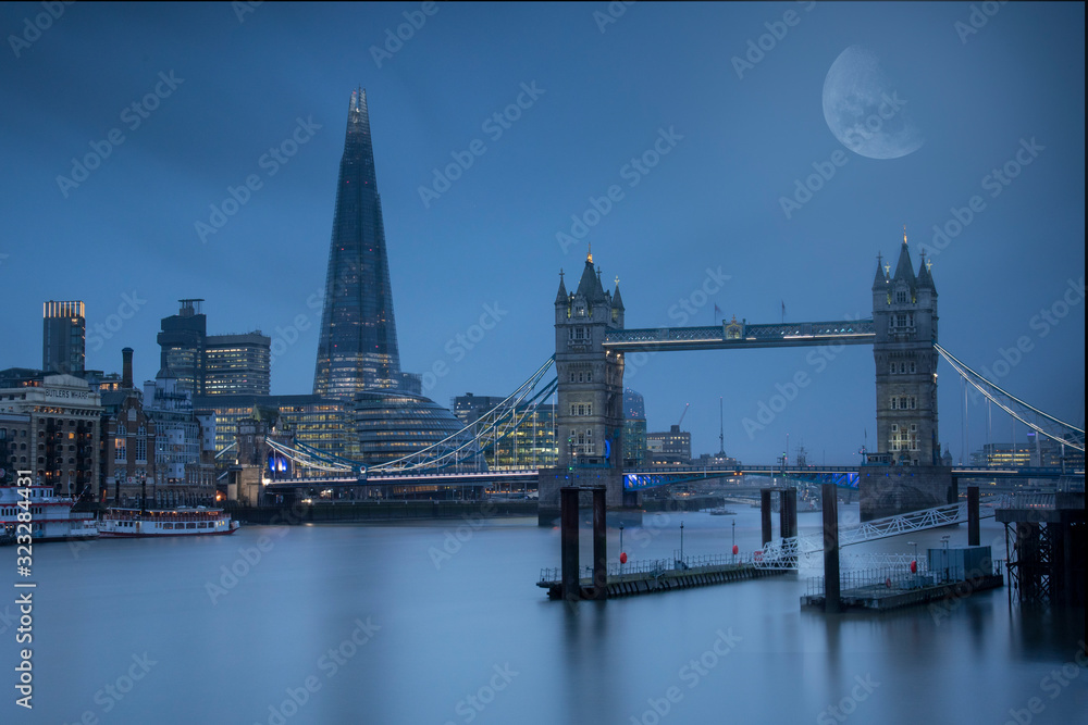 Naklejka premium Moon lit view over the Thames, taking in Tower Bridge, The Shard and City Hall