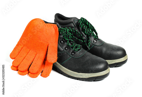 Work leather shoes and  gloves isolated on white background. Worker safety photo