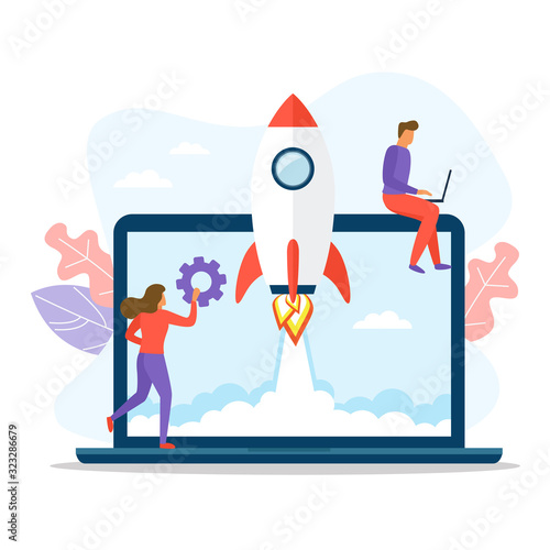 People working near a big laptop and rocket taking off