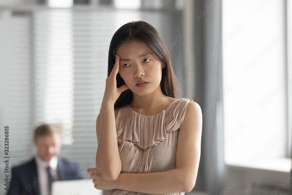 Tired Asian employee feel bored lacking motivation Tired Asian employee feel bored lacking motivation
