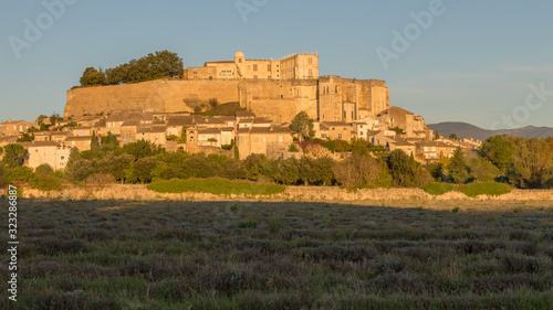 The castle and the village of Grignan behind a lavender field, Provence