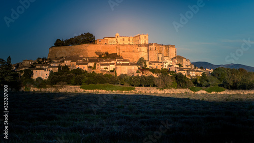 The castle and the village of Grignan behind a lavender field, Provence