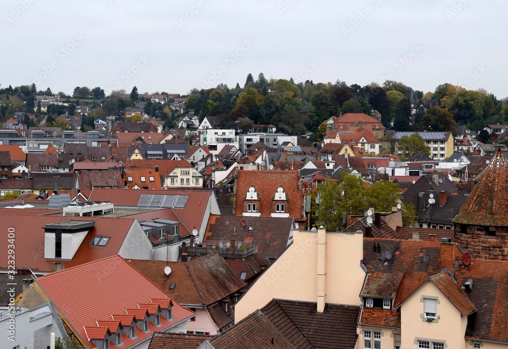 high angle view across the roofs of downtown buildings with partial view of the Storchenturm landmark Lahr Baden Germany