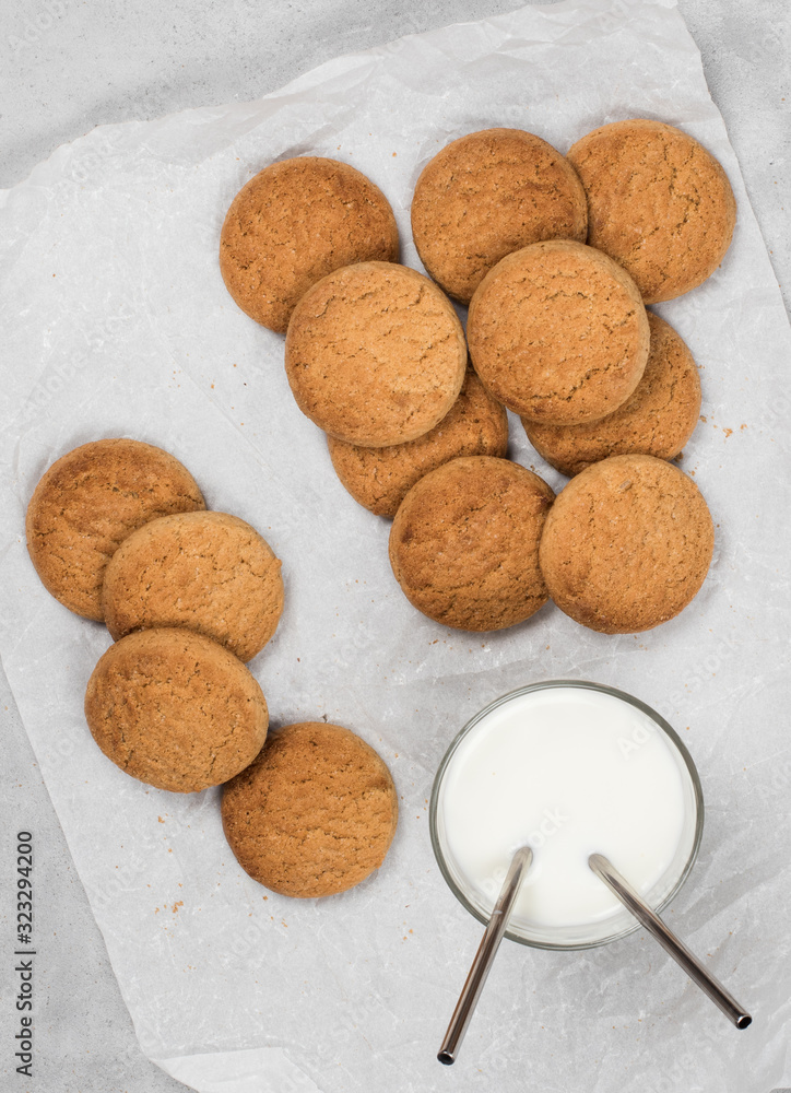 Shortbread oatmeal cookies with milk on a dark gray background Shortbread oatmeal cookies with milk on a dark gray background
