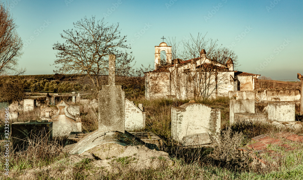 Abandoned church ruin and cemetery overgrown landscape