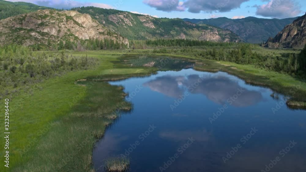 Flying over the river in the water reflected clouds background mountains 4k Flying over the river in the water reflected clouds background mountains 4k