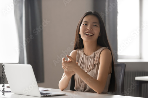 Happy Asian female employee applaud excited for success