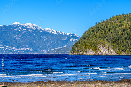 Fantastic view over ocean, snow mountain and rocks at Furry Creek Dive Site in Vancouver, Canada.