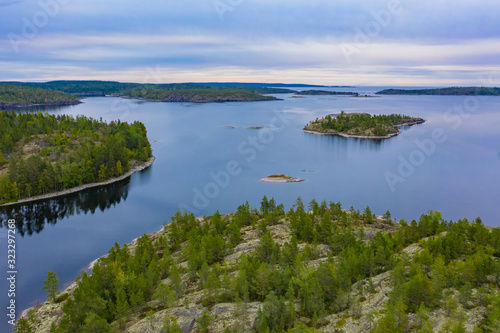 Russia. Karelia. Ladoga. Lake in the Russian taiga. Skerries of Ladoga Lake. Karelia on a summer day. Coniferous forest near the lake. Landscapes of Russia. Northern nature. Tours in Russia.