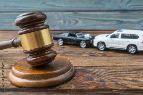 Judge gavel and two cars colliding, traffic accident, insurance, fault. Court law