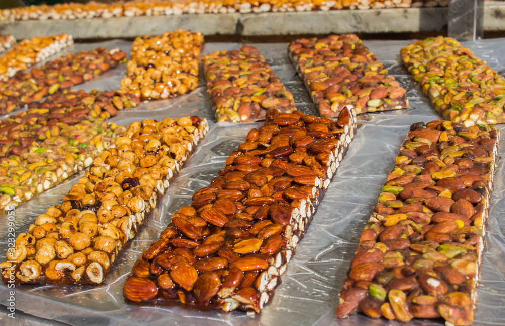 Walnut, almond and Pistachio nut bars on the table, Mediterranean sweets.