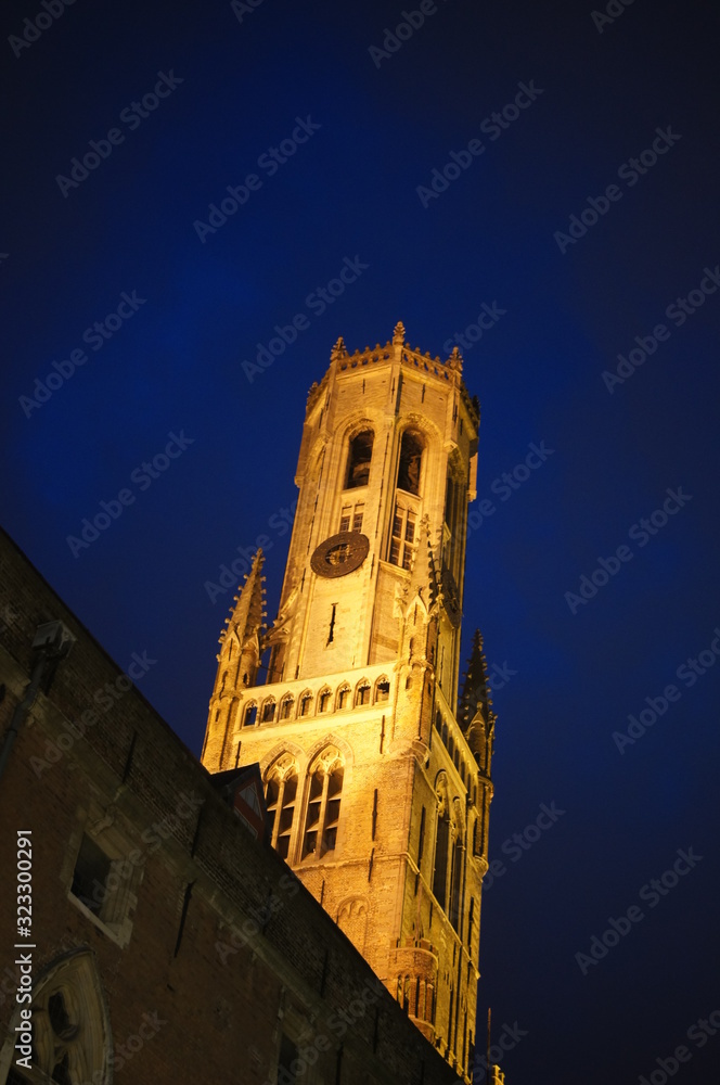 Bruges by night the church,church, tower, architecture, building, cathedral, religion, sky, europe, old, city, clock, blue, travel, landmark, tourism, history, town, 