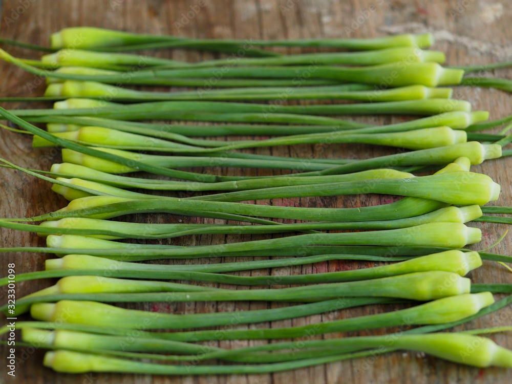 Sliced garlic sticks are very tender and delicious. They are also known as garlic spears , stems , or tops . Sliced garlic sticks are very tender and delicious. They are also known as garlic spears , stems , or tops .
