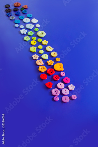 Path made of multicolor buttons on blue background