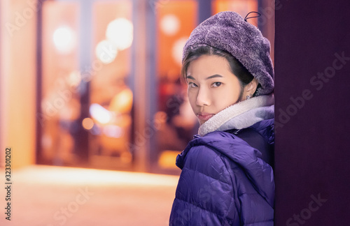 Woman in winter fashion Beauty skin cosmetic with orange toned background in Sendai Japan. photo