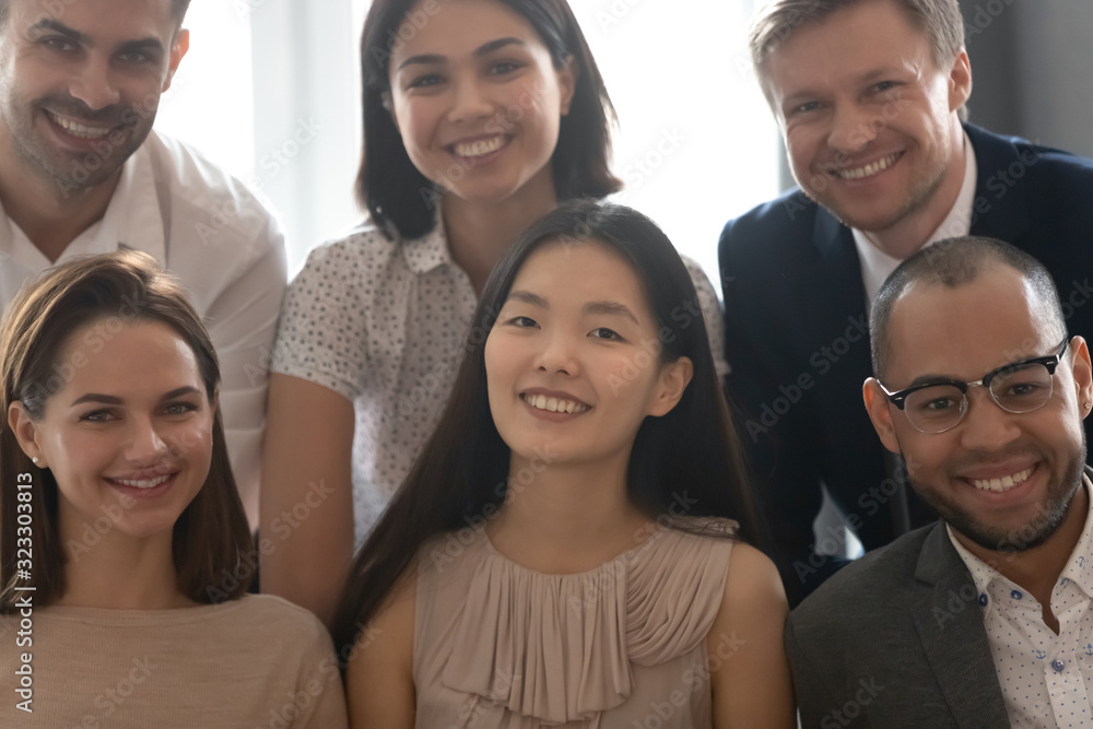 Close up portrait of diverse colleagues smile look at camera Close up portrait of diverse colleagues smile look at camera