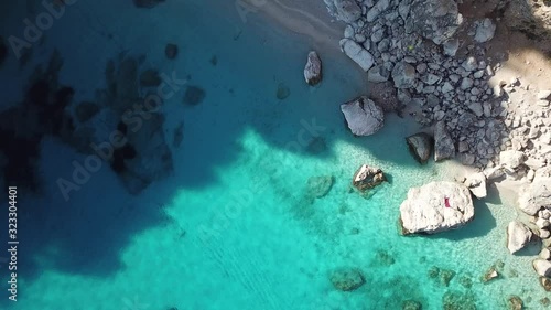 Aerial drone video in paradise of Cala Goloritze, Sardinia, Italy. Turquoise crystal clear water in front of the beach.  photo