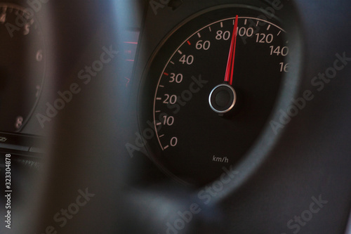 high speed on speedometer in automobile on dark background