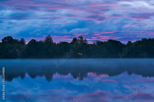 Landscape at dawn of Whitford Lake in fog, Fort Custer State Park, Michigan, USA