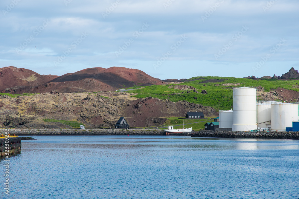 Obraz premium Fish oil tanks and historic buildings in Vestmannaeyjar Iceland